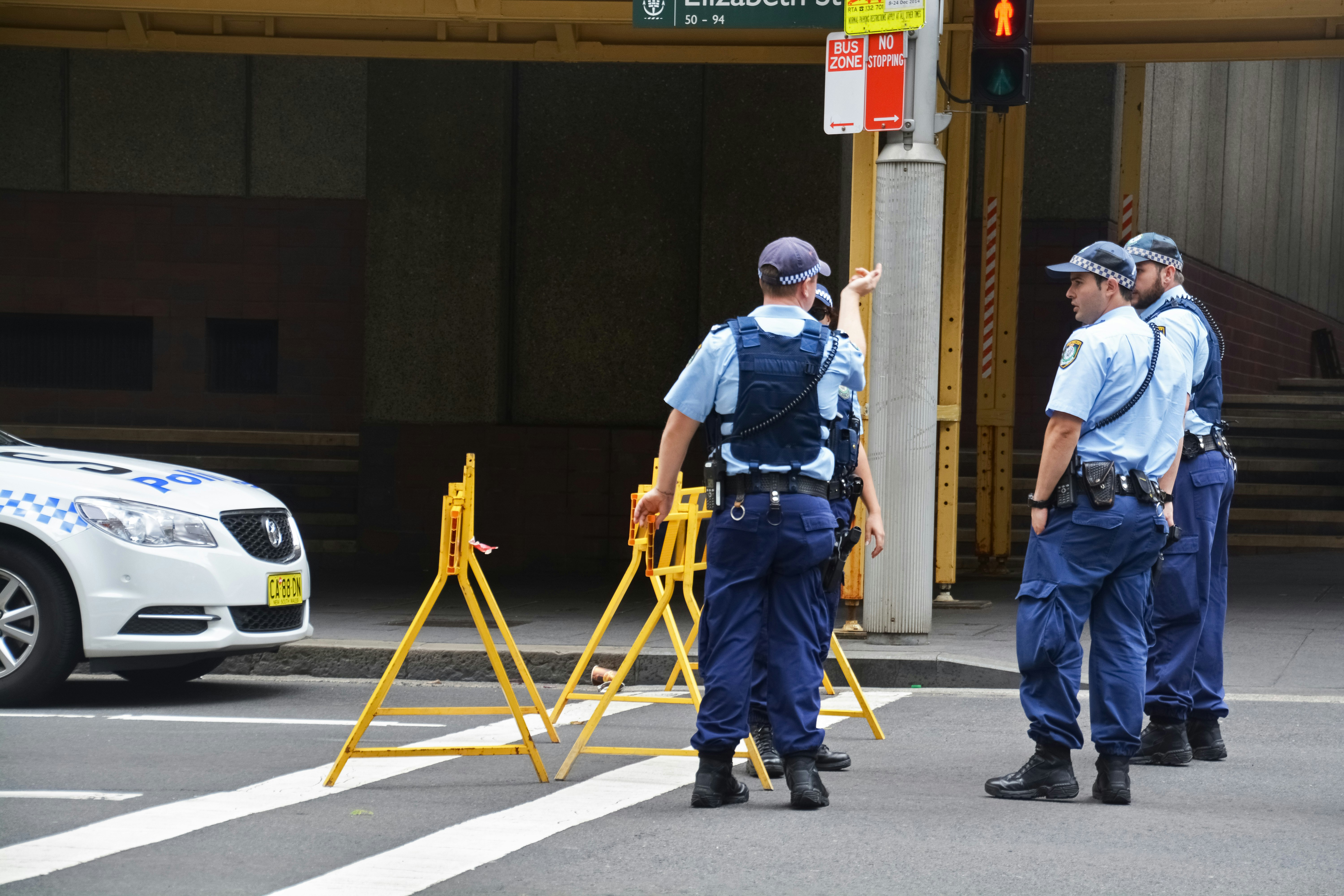 man in blue denim jeans and blue shirt walking on pedestrian lane during daytime